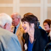 President Philomena Mantella talking with a couple guests.